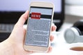 Online news on a mobile phone. Close up of businesswoman reading news or articles in a smartphone screen application. Royalty Free Stock Photo