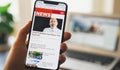 Online news on a smart phone. Close up of businessman reading news or articles in a mobile phone screen app. Hand holding smart Royalty Free Stock Photo