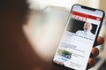 Online news on a smart phone. Close up of businessman reading news or articles in a mobile phone screen app. Hand holding smart Royalty Free Stock Photo