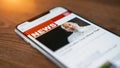 Online news on a smart phone. Close up of businessman reading news or articles in a mobile phone screen app. Hand holding smart Royalty Free Stock Photo