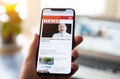 Online news on a smart phone. Close up of businessman reading news or articles in a mobile phone screen app. Hand holding smart Royalty Free Stock Photo