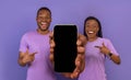 Online Offer. Positive African American Couple Pointing At Smartphone With Blank Screen Royalty Free Stock Photo