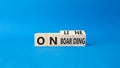 Online Onboarding symbol. Turned wooden cubes with words Online Onboarding. Beautiful blue background. Business and Online