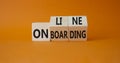 Online Onboarding symbol. Turned wooden cubes with words Online Onboarding. Beautiful orange background. Business and Online