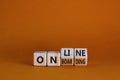 Online onboarding symbol. Turned wooden cubes with words `online onboarding`. Beautiful orange table, orange background, copy