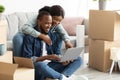 Online Order. Happy Young Black Couple With Laptop Choosing Furniture In Internet Royalty Free Stock Photo