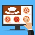 Online order pizza via the Internet. The choice of pizza on the computer Royalty Free Stock Photo