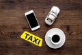 Online order a taxi set with car toy, coffee and mobile on wooden background top view mock up Royalty Free Stock Photo