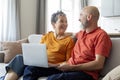 Online Pastime. Cheerful Senior Spouses Using Laptop At Home Together Royalty Free Stock Photo