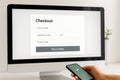 Online payment checkout process on computer screen and smartphone Royalty Free Stock Photo