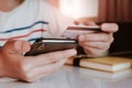 Online payment, Woman`s hands holding a credit card and using smart phone Royalty Free Stock Photo