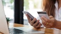 Online payment woman`s hands holding smartphone and using credit card for online shopping. Cyber Monday Concept Royalty Free Stock Photo