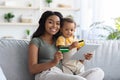 Online Payments. Black Mom And Child Using Digital Tablet And Credit Cards Royalty Free Stock Photo