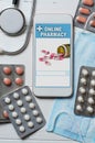 Online pharmacy. Application in smartphone for online ordering of medicines. Lots of pills, stethoscope and the