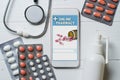 Online pharmacy. Application in smartphone for online ordering of medicines. Lots of pills, stethoscope and spray with medication