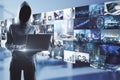 Online piracy concept with noface hacker with laptop on media wall Royalty Free Stock Photo