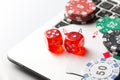 Online poker casino theme. Gambling chips with dice and playing cards on laptop Royalty Free Stock Photo