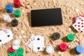 Online poker game on the beach with digital tablet and stacks of chips. Top view Royalty Free Stock Photo