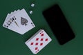 Online poker games. four aces with dice and phone in casino Royalty Free Stock Photo