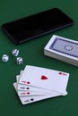 Online poker games. four aces with dice and phone in casino