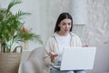 Online psychotherapy. A young worried woman is sitting at home with laptop Royalty Free Stock Photo