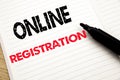 Online Registration. Business concept for Internet Login written on notebook with copy space on book background with marker pen