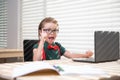 Online remote learning. School kids with computer having video conference chat with teacher in class. Child studying at Royalty Free Stock Photo