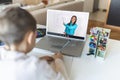 Online remote learning. School kids with computer having video conference chat with teacher and class group. Child studying from Royalty Free Stock Photo