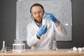 Online remote learning. Teacher with chemical flask showing experiments having video conference chat with student and Royalty Free Stock Photo