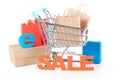 Online Sale Shopping Concept: Shopping Cart with Paper Bags and \'Sale\' Sign on White Background Royalty Free Stock Photo