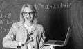 Online schooling concept. Woman wear eyeglasses holds laptop surfing internet. Great resource for teachers. Educator