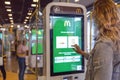 Online service McDonald`s inside. The girl makes an order by touching the monitor screen. Moscow, Russia, 08/25/2020