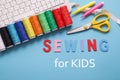 Online sewing courses. Sewing for kids. Tools for sew, multicolor threads, white keyboard. learn to sew