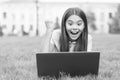 Online shop. happy blogging. girl sitting on green grass with laptop. Start up. child playing computer game. back to Royalty Free Stock Photo