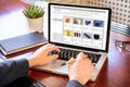 Online shop website developer working with a laptop, office desk background