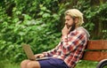 Online shopping. Agile business. Bearded guy sit on bench in park nature background. Work and relax. Working online Royalty Free Stock Photo