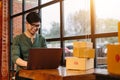 Online shopping asian young start small business in a cardboard box at work. The seller prepares the delivery box for the customer