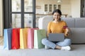 Online Shopping. Beautiful Indian Woman Using Laptop And Credit Card At Home Royalty Free Stock Photo