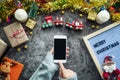 Online shopping for Christmas season and gift festival. hand holding mobile phone with blank screen and press button for shopping Royalty Free Stock Photo