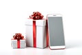 Online shopping concept. E-commerce. Mobile phone, smartphone and white gift beautiful boxes with red ribbon on a white background Royalty Free Stock Photo