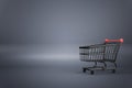 Online shopping concept with empty black supermarket shopping cart on dark background. Mockup