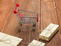 Online shopping concept - Empty Shopping Cart, laptop and tablet pc, gift box on rustic wooden background Royalty Free Stock Photo