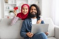 Online Shopping. Happy Muslim Couple Using Laptop And Credit Card At Home, Royalty Free Stock Photo