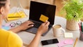 Black woman using laptop and credit card at home Royalty Free Stock Photo