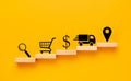 Online shopping concept. sequence of icons on wooden blocks - magnifier, basket, dollar, delivery car, geolocation mark.