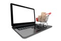 Online shopping concept. Shopping Cart with Boxes over Laptop