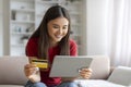 Online Shopping Concept. Smiling Asian Woman Using Digital Tablet And Credit Card Royalty Free Stock Photo