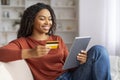 Online Shopping Concept. Smiling Black Woman Using Digital Tablet And Credit Card Royalty Free Stock Photo