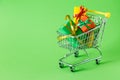 Online shopping concept - trolley cart full of presents