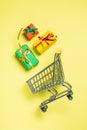 Online shopping concept - trolley cart full of presents